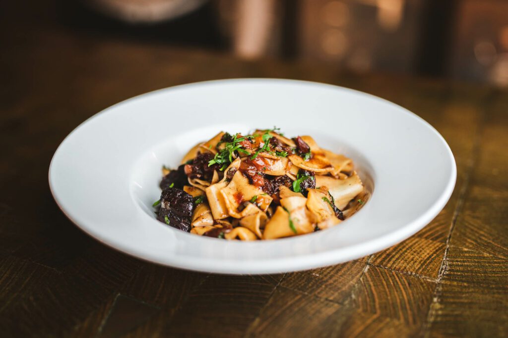 A bowl of pasta topped with mushrooms from Rusty Fig Perth